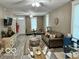 Spacious living room with hardwood floors, comfortable seating, and a dining area at 1202 S Shipley St, Muncie, IN 47302