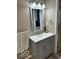 Modern bathroom with gray vanity, updated fixtures, and a large mirror at 1202 S Shipley St, Muncie, IN 47302