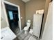 Clean bathroom with toilet, storage cabinet, and view into adjacent room at 1202 S Shipley St, Muncie, IN 47302