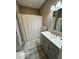Updated bathroom with a shower/tub combo, gray vanity, and neutral decor at 1202 S Shipley St, Muncie, IN 47302