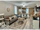 Open concept living room with hardwood floors, modern furniture, and kitchen views at 1202 S Shipley St, Muncie, IN 47302