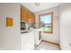 Bright laundry room with washer, dryer, and cabinets at 1936 Broadmoor Ln, Columbus, IN 47203
