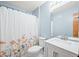 Bathroom with shower, toilet, and floral curtain at 1936 Broadmoor Ln, Columbus, IN 47203