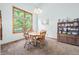 Cozy dining area with wood table and chairs, and a view to the backyard at 1936 Broadmoor Ln, Columbus, IN 47203