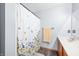 Clean bathroom with shower and floral curtain at 1936 Broadmoor Ln, Columbus, IN 47203