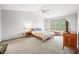 Spacious bedroom with a queen bed, ceiling fan, and large window at 1936 Broadmoor Ln, Columbus, IN 47203