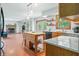 Open kitchen with island, stainless steel appliances, and hardwood floors at 1936 Broadmoor Ln, Columbus, IN 47203