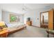 Large bedroom with a queen bed, ceiling fan, and access to a hallway at 1936 Broadmoor Ln, Columbus, IN 47203