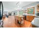 Open kitchen with island, stainless steel appliances, and hardwood floors at 1936 Broadmoor Ln, Columbus, IN 47203