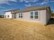 Rear view of a ranch home with gray siding, multiple windows, and a covered patio at 6205 Card Blvd, Indianapolis, IN 46221