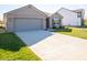 New construction home with gray garage door and driveway at 6205 Card Blvd, Indianapolis, IN 46221
