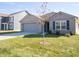 Newly built home with gray garage door and small tree at 6205 Card Blvd, Indianapolis, IN 46221