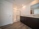Bathroom with double vanity, shower, and wood-look floors at 6205 Card Blvd, Indianapolis, IN 46221