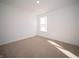 Well-lit bedroom featuring neutral walls and carpet at 6205 Card Blvd, Indianapolis, IN 46221