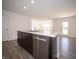 Kitchen island with sink, dishwasher, and view to living room at 6205 Card Blvd, Indianapolis, IN 46221
