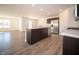Modern kitchen with island, stainless steel appliances, and wood-look floors at 6205 Card Blvd, Indianapolis, IN 46221