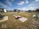 Community lawn games area with cornhole and benches at 6205 Card Blvd, Indianapolis, IN 46221