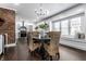 Charming dining area with a dark wood table and woven chairs, exposed brick wall at 1210 Finley Ave, Indianapolis, IN 46203