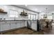Modern kitchen with white cabinets, granite countertops, and a view of the dining area at 1210 Finley Ave, Indianapolis, IN 46203