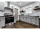 Modern kitchen featuring stainless steel appliances and dark wood floors at 1210 Finley Ave, Indianapolis, IN 46203