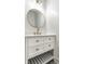 Bathroom with white vanity, oval mirror, and gold fixtures at 1210 Finley Ave, Indianapolis, IN 46203
