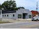 Exterior view of Helm Coffee Shop, a modern gray building with black accents at 1210 Finley Ave, Indianapolis, IN 46203