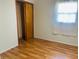 Bedroom with wood-look flooring, a closet, and a window with curtains at 2416 Radcliffe Ave, Indianapolis, IN 46227