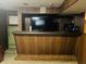 Basement bar area with tv and wood paneling at 2416 Radcliffe Ave, Indianapolis, IN 46227