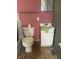 Small bathroom with white vanity, toilet and pink walls at 2416 Radcliffe Ave, Indianapolis, IN 46227