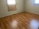 Spacious bedroom featuring wood-look flooring and a large window at 2416 Radcliffe Ave, Indianapolis, IN 46227