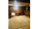 Finished basement with wood paneling, bar area, and carpeted floor at 2416 Radcliffe Ave, Indianapolis, IN 46227
