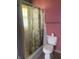 Bathroom with shower stall, toilet, and pink walls at 2416 Radcliffe Ave, Indianapolis, IN 46227