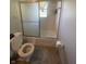 Simple bathroom with a shower/tub combo, toilet, and tile flooring at 2416 Radcliffe Ave, Indianapolis, IN 46227