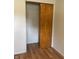 Standard bedroom closet with wood sliding doors and laminate flooring at 2416 Radcliffe Ave, Indianapolis, IN 46227