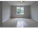 Spacious bedroom with carpeted floor and large window at 150 S Main St # 203, Franklin, IN 46131
