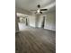 Spacious living room with gray walls, wood-look floors, and a ceiling fan at 1628 Churchman Ave, Indianapolis, IN 46203