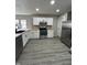 Modern white kitchen with stainless steel appliances and gray flooring at 1628 Churchman Ave, Indianapolis, IN 46203