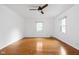 Bright bedroom featuring hardwood floors and ceiling fan at 7201 N Illinois St, Indianapolis, IN 46260