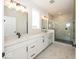 Bathroom with double vanity, large shower, and marble tile at 6425 Ambassador Dr, Plainfield, IN 46168