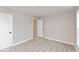 Empty bedroom with gray walls, plush carpeting, and white doors at 1098 Gatewick Ct, Greenwood, IN 46143