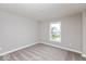 Unfurnished bedroom featuring neutral gray walls, plush carpeting, and a large window at 1098 Gatewick Ct, Greenwood, IN 46143