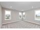 Empty bedroom with neutral gray walls, plush carpeting, and multiple windows offering natural light at 1098 Gatewick Ct, Greenwood, IN 46143