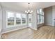Sunlit dining space with large windows overlooking the backyard and a door leading outside at 1098 Gatewick Ct, Greenwood, IN 46143
