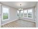 Dining area with large windows offering ample natural light and wood-look flooring at 1098 Gatewick Ct, Greenwood, IN 46143