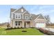 Charming two-story home with a landscaped yard and attached garage at 1098 Gatewick Ct, Greenwood, IN 46143