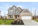 Inviting two-story home with a brick and siding exterior, front yard landscaping, and attached garage at 1098 Gatewick Ct, Greenwood, IN 46143