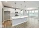 Spacious kitchen with white cabinets, quartz countertops, a center island, and stainless steel appliances at 1098 Gatewick Ct, Greenwood, IN 46143