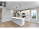 Modern kitchen featuring white cabinets, a large island, stainless steel appliances, and wood-look flooring at 1098 Gatewick Ct, Greenwood, IN 46143