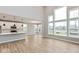Open-concept living area with kitchen, dining area, and large windows overlooking neighborhood at 1098 Gatewick Ct, Greenwood, IN 46143