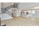 Spacious open-concept living room with a view of the kitchen, a staircase, and high ceilings at 1098 Gatewick Ct, Greenwood, IN 46143
